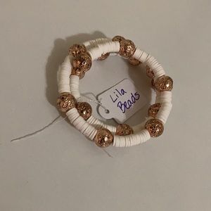 Made with white heishi beads and rose gold lava rock beads.